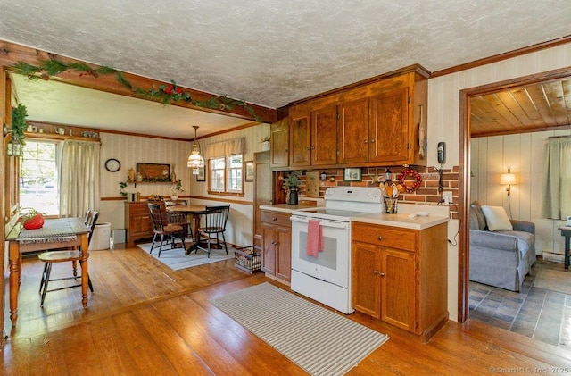 39 Mohawk Ln, Wethersfield, CT 06109 - kitchen featuring electric stove, wood-type flooring, light countertops, brown cabinets, and crown molding