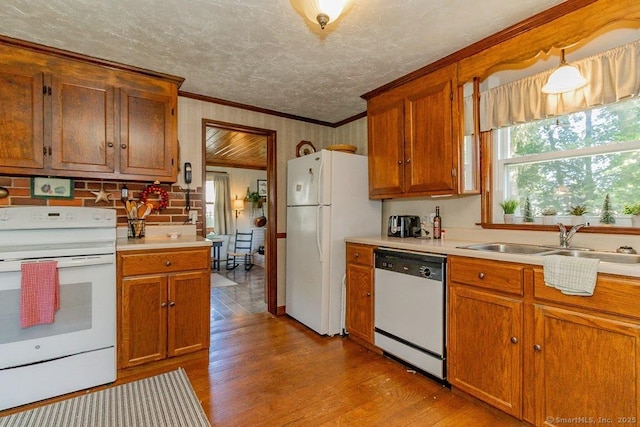 39 Mohawk Ln, Wethersfield, CT 06109 - kitchen with white appliances, crown molding, wood finished floors, light countertops, and brown cabinetry