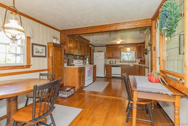 39 Mohawk Ln, Wethersfield, CT 06109 - dining area with dark wood-style floors, crown molding, and a chandelier