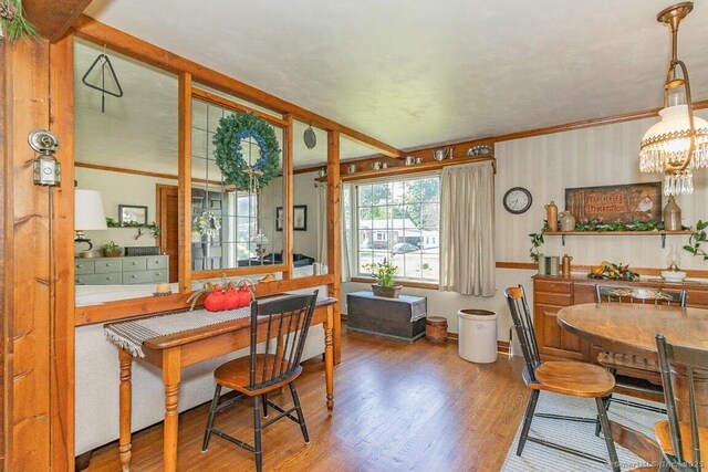 39 Mohawk Ln, Wethersfield, CT 06109 - dining room featuring wood finished floors, ornamental molding, wallpapered walls, and a chandelier