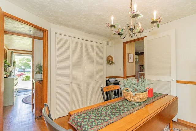 39 Mohawk Ln, Wethersfield, CT 06109 - dining space featuring a chandelier, wood finished floors, and a textured ceiling
