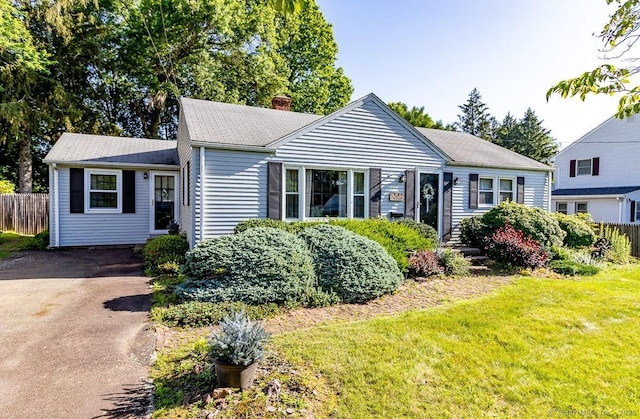39 Mohawk Ln, Wethersfield, CT 06109 - view of front facade featuring a chimney and asphalt driveway