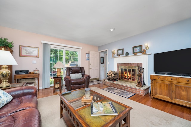 135 Harvest Woods Rd, Middlefield, CT 06481 - living area with a fireplace and wood finished floors