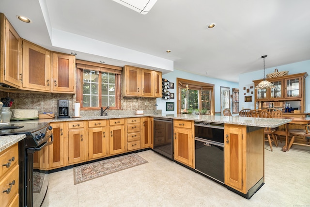 135 Harvest Woods Rd, Middlefield, CT 06481 - kitchen featuring black appliances, a peninsula, healthy amount of natural light, decorative backsplash, and recessed lighting