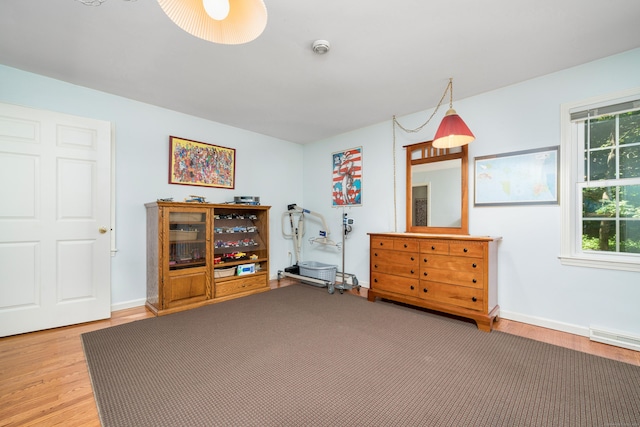 135 Harvest Woods Rd, Middlefield, CT 06481 - living area featuring light wood-style flooring, plenty of natural light, and a baseboard radiator