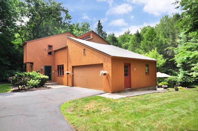 11 Brianwood Ln, Granby, CT 06035 - view of front of property featuring an attached garage, a front yard, asphalt driveway, and a shingled roof