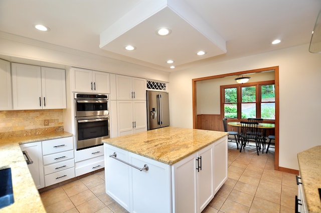 11 Brianwood Ln, Granby, CT 06035 - kitchen featuring stainless steel appliances, light tile patterned floors, decorative backsplash, white cabinets, and recessed lighting