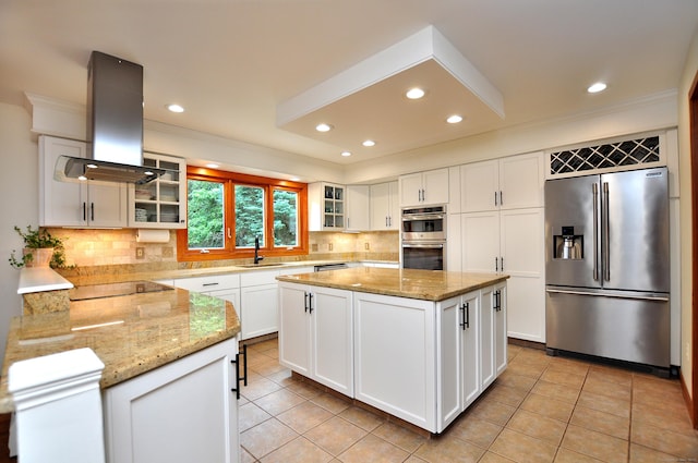 11 Brianwood Ln, Granby, CT 06035 - kitchen with stainless steel appliances, island exhaust hood, backsplash, light stone counters, and light tile patterned flooring