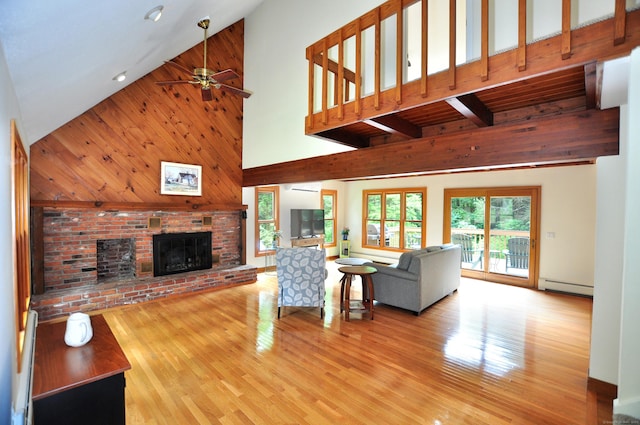 11 Brianwood Ln, Granby, CT 06035 - living room featuring a baseboard heating unit, high vaulted ceiling, a brick fireplace, wood finished floors, and ceiling fan