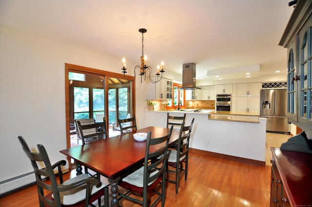 11 Brianwood Ln, Granby, CT 06035 - dining area with a chandelier, recessed lighting, light wood finished floors, and a baseboard radiator