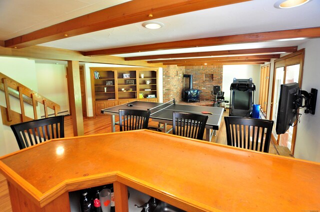 11 Brianwood Ln, Granby, CT 06035 - playroom featuring a wood stove, wood finished floors, and beam ceiling