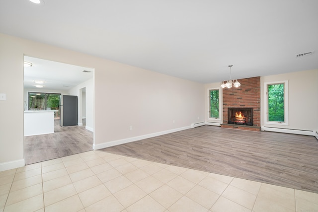 1037 Bartholomew Rd, Middletown, CT 06457 - unfurnished living room with light wood finished floors, a baseboard radiator, a chandelier, and a brick fireplace