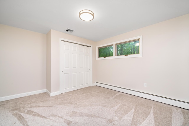1037 Bartholomew Rd, Middletown, CT 06457 - unfurnished bedroom featuring a baseboard heating unit, carpet flooring, and a closet