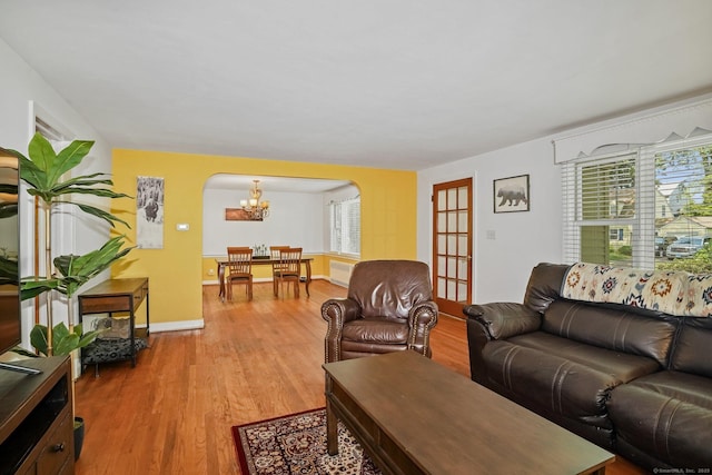 57 Lakeview Ave, Hamden, CT 06514 - living area with arched walkways, light wood finished floors, and a chandelier