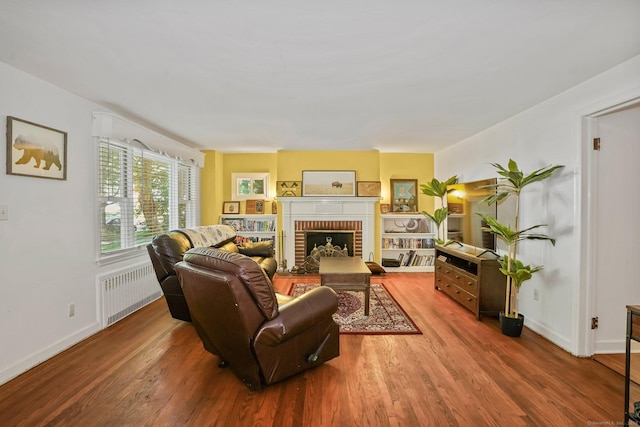 57 Lakeview Ave, Hamden, CT 06514 - living area featuring radiator heating unit, wood finished floors, and a fireplace