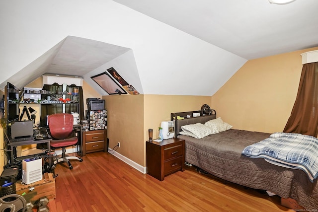 57 Lakeview Ave, Hamden, CT 06514 - bedroom with wood finished floors, vaulted ceiling, and an office area