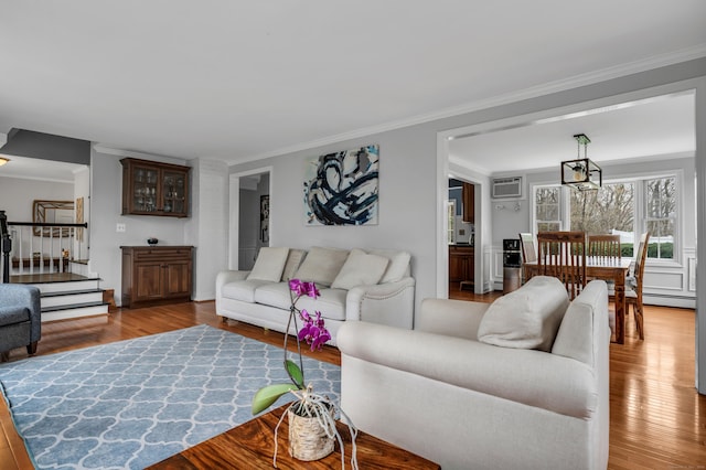 60 Ledgeview Ln, Guilford, CT 06437 - living area featuring wood finished floors, ornamental molding, a wall unit AC, stairs, and baseboard heating