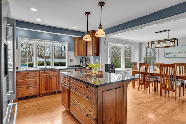 60 Ledgeview Ln, Guilford, CT 06437 - kitchen featuring brown cabinetry, dishwashing machine, dark stone counters, hanging light fixtures, and recessed lighting