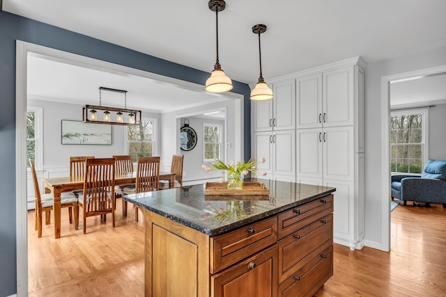 60 Ledgeview Ln, Guilford, CT 06437 - kitchen with light wood-type flooring, healthy amount of natural light, white cabinetry, and hanging light fixtures