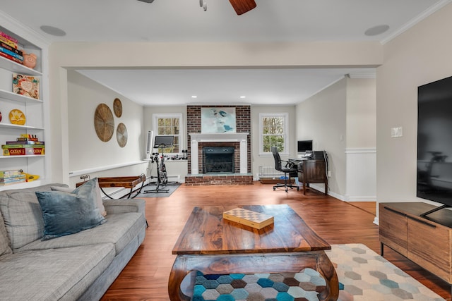 60 Ledgeview Ln, Guilford, CT 06437 - living area featuring wood finished floors, ornamental molding, ceiling fan, a desk, and a brick fireplace