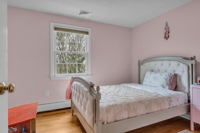 60 Ledgeview Ln, Guilford, CT 06437 - bedroom with a baseboard radiator and wood finished floors