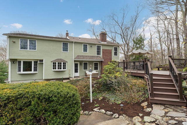 60 Ledgeview Ln, Guilford, CT 06437 - back of property with a deck, a chimney, and stairs