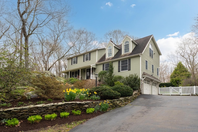 60 Ledgeview Ln, Guilford, CT 06437 - view of front of property with a gate, asphalt driveway, an attached garage, and a porch