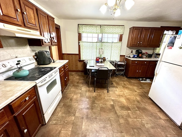 734 Howe Ave, Shelton, CT 06484 - kitchen with white appliances, under cabinet range hood, healthy amount of natural light, light countertops, and wainscoting