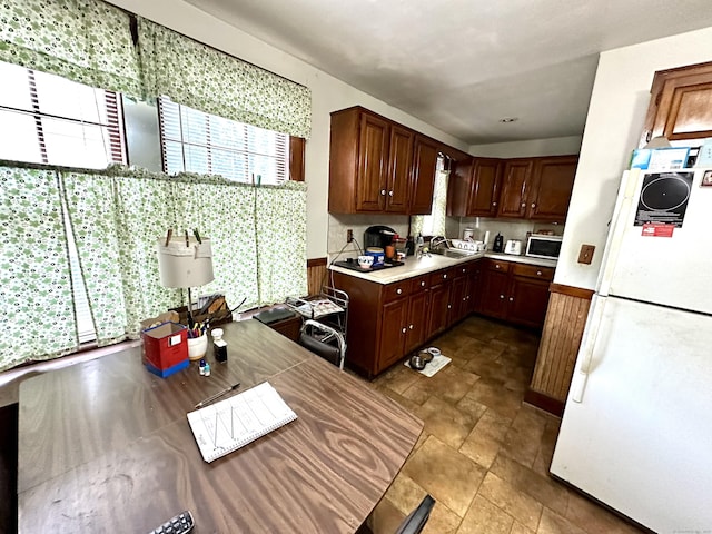 734 Howe Ave, Shelton, CT 06484 - kitchen featuring freestanding refrigerator, light countertops, and stone finish floors