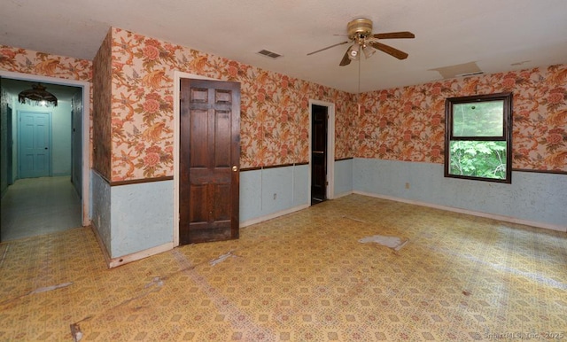 479 Kettletown Rd, Southbury, CT 06488 - empty room featuring wallpapered walls, ceiling fan, and a wainscoted wall