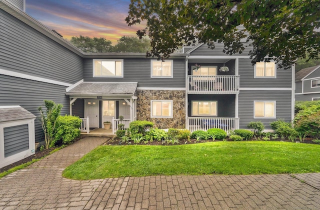 205 Windgate Cir Unit A, Monroe, CT 06468 - view of front facade with a porch, stone siding, and a front lawn