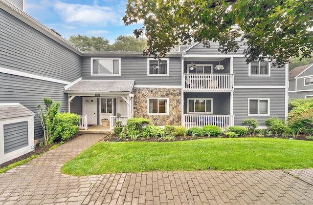 205 Windgate Cir Unit A, Monroe, CT 06468 - view of front of property with covered porch, stone siding, and a front yard