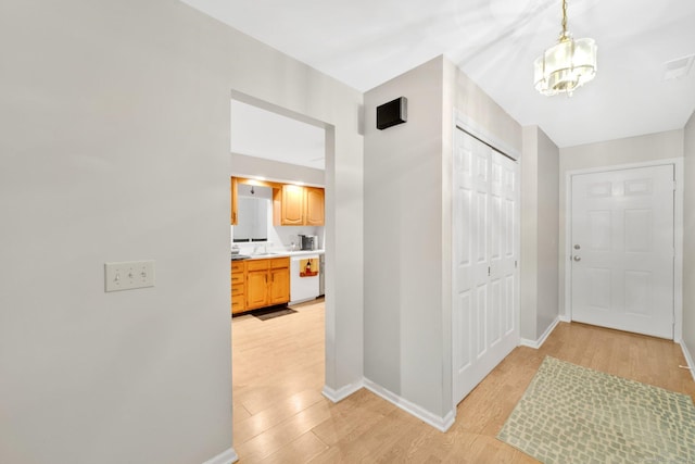 205 Windgate Cir Unit A, Monroe, CT 06468 - foyer entrance featuring light wood-style flooring and a chandelier