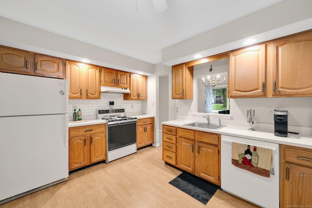 205 Windgate Cir Unit A, Monroe, CT 06468 - kitchen with white appliances, under cabinet range hood, light wood finished floors, tasteful backsplash, and light countertops