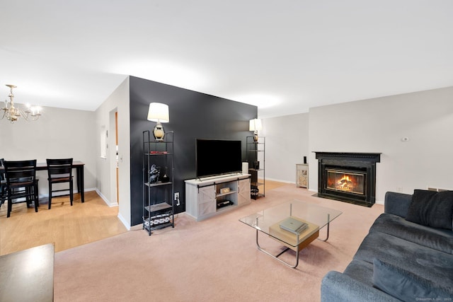 205 Windgate Cir Unit A, Monroe, CT 06468 - living area with a chandelier, a fireplace with flush hearth, and light colored carpet