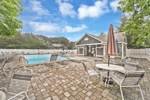 205 Windgate Cir Unit A, Monroe, CT 06468 - community pool with a fenced backyard, a patio area, and an outbuilding