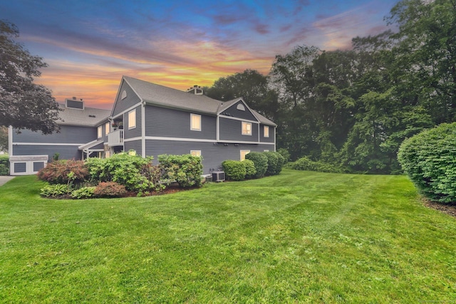 205 Windgate Cir Unit A, Monroe, CT 06468 - property exterior at dusk featuring a yard and a garage