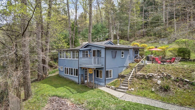 25 Brookbridge Dr, Newtown, CT 06482 - chalet / cabin with stairway, a chimney, a front lawn, a deck, and a wooded view