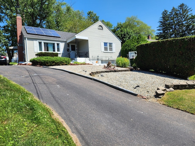 1014 N Worthy St, Windsor, CT 06095 - single story home with solar panels and a chimney