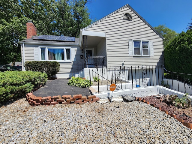 1014 N Worthy St, Windsor, CT 06095 - view of front of property featuring solar panels and a chimney