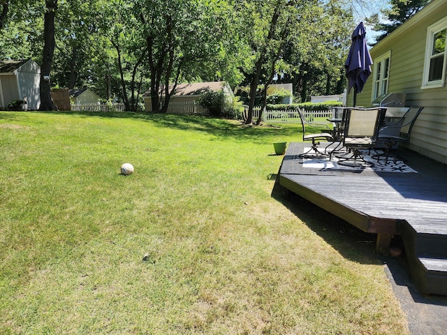 1014 N Worthy St, Windsor, CT 06095 - fenced backyard with a wooden deck, outdoor dining area, and a storage shed