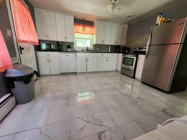 1014 N Worthy St, Windsor, CT 06095 - kitchen with appliances with stainless steel finishes, dark countertops, and light marble finish flooring