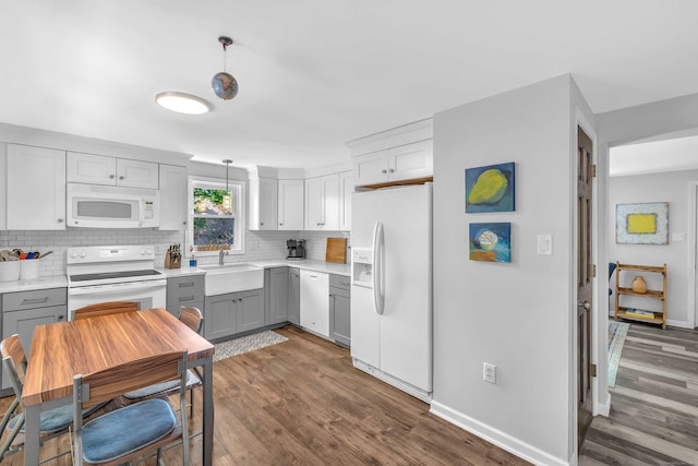 130 Irving St, Groton, CT 06355 - kitchen with white appliances, gray cabinets, dark wood-type flooring, tasteful backsplash, and light countertops