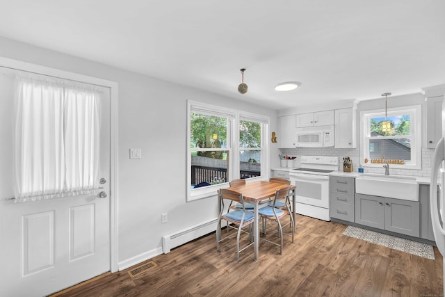 130 Irving St, Groton, CT 06355 - kitchen with white appliances, gray cabinetry, wood finished floors, and decorative backsplash