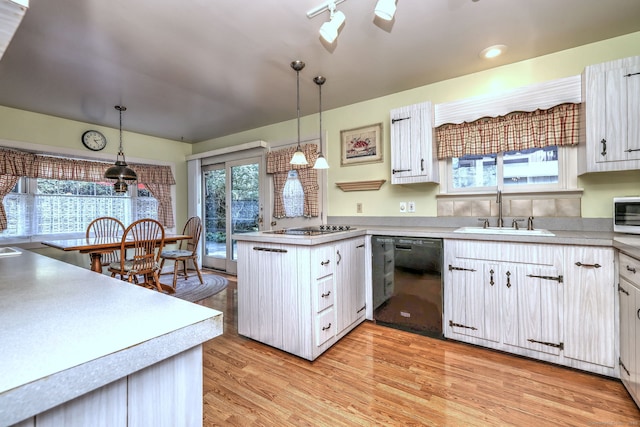 21 Oakwood Ave, Waterbury, CT 06708 - kitchen with black appliances, a peninsula, white cabinets, light wood-type flooring, and plenty of natural light