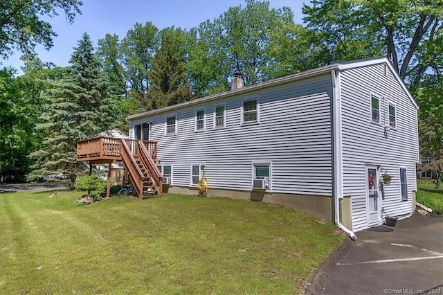 43 Plumtrees Rd Unit A, Bethel, CT 06801 - back of property with a wooden deck, stairway, a lawn, and a chimney