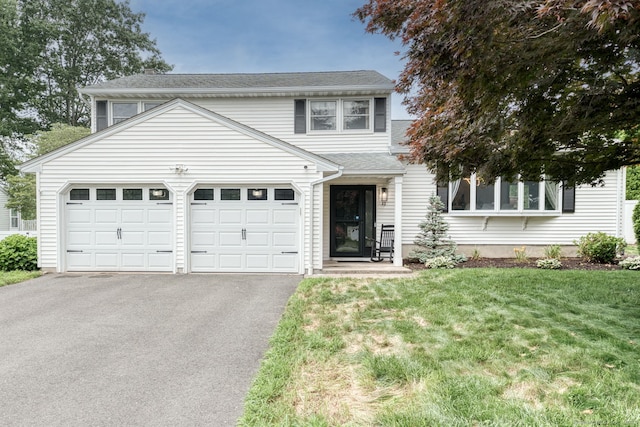 32 Patriot Ln, Newington, CT 06111 - view of front of home featuring asphalt driveway, an attached garage, a front yard, and a shingled roof