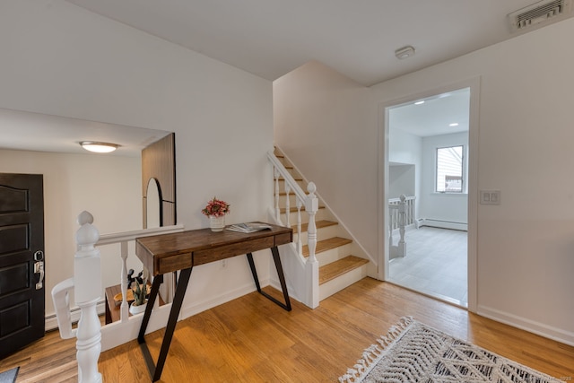 32 Patriot Ln, Newington, CT 06111 - foyer featuring baseboard heating, light wood-style flooring, and stairway