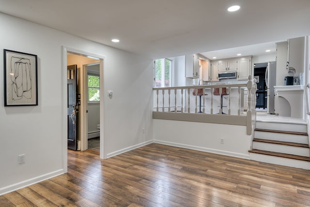 32 Patriot Ln, Newington, CT 06111 - unfurnished living room featuring wood-type flooring, recessed lighting, and baseboard heating
