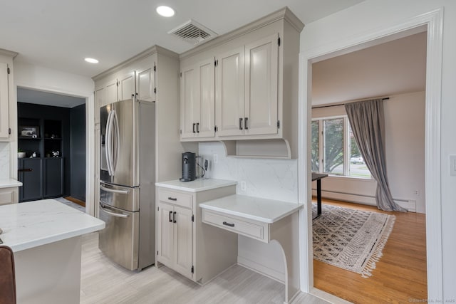32 Patriot Ln, Newington, CT 06111 - kitchen with stainless steel fridge with ice dispenser, baseboard heating, recessed lighting, decorative backsplash, and light wood-style floors